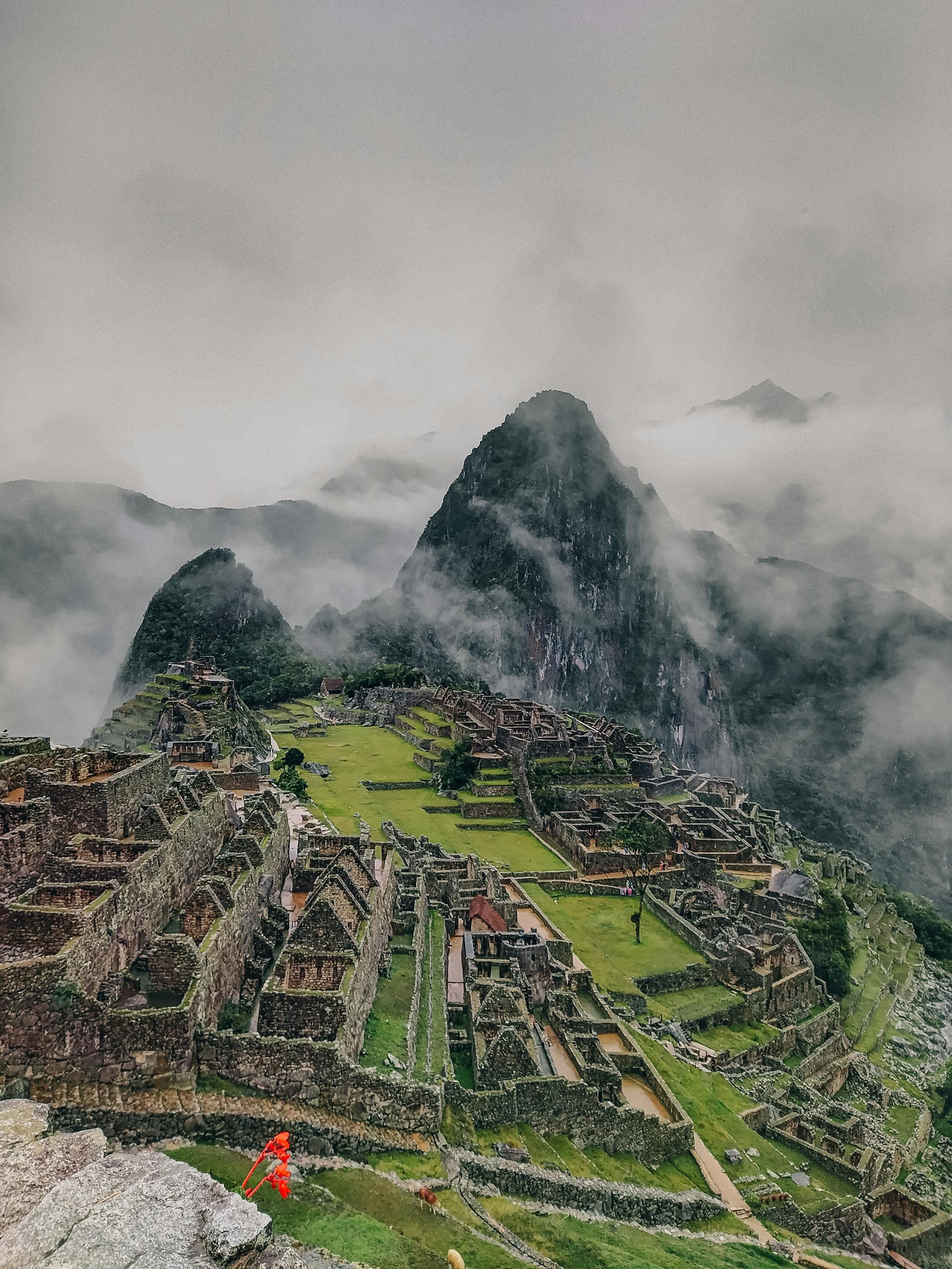 Breathtaking image of Machu Picchu shrouded in mist, showcasing iconic Inca ruins.